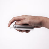 Hand holding the compact Überlube Good-to-Go case